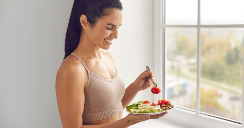 Fitness woman eating balanced healthy meal