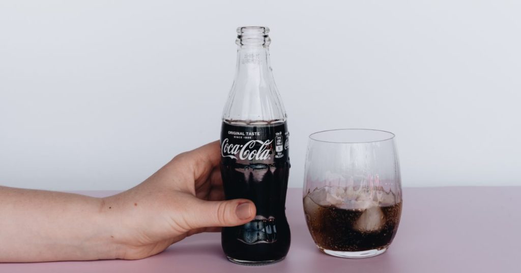 Photo of person holding bottled soft drinks