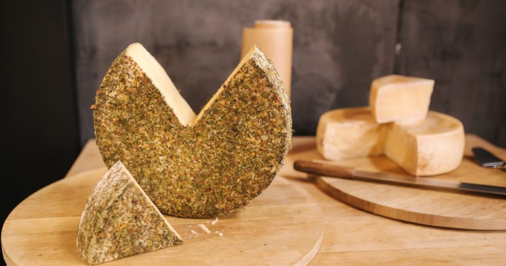 Big piece of lactose free cheese on wooden board